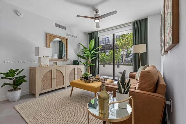 a living room with furniture and a potted plant