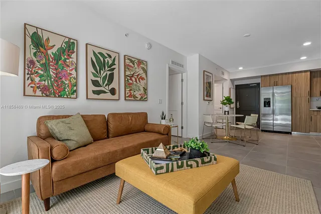 a living room with furniture and painting on the wall