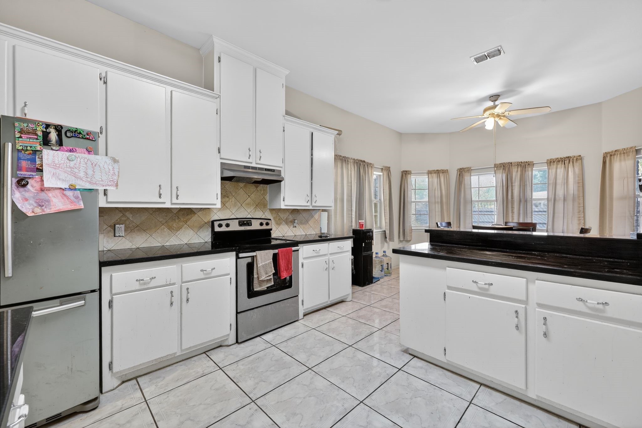 901 Royal Street Edinburg, TX 78539 - Photo 13 of 30 a kitchen with granite countertop white cabinets and white appliances