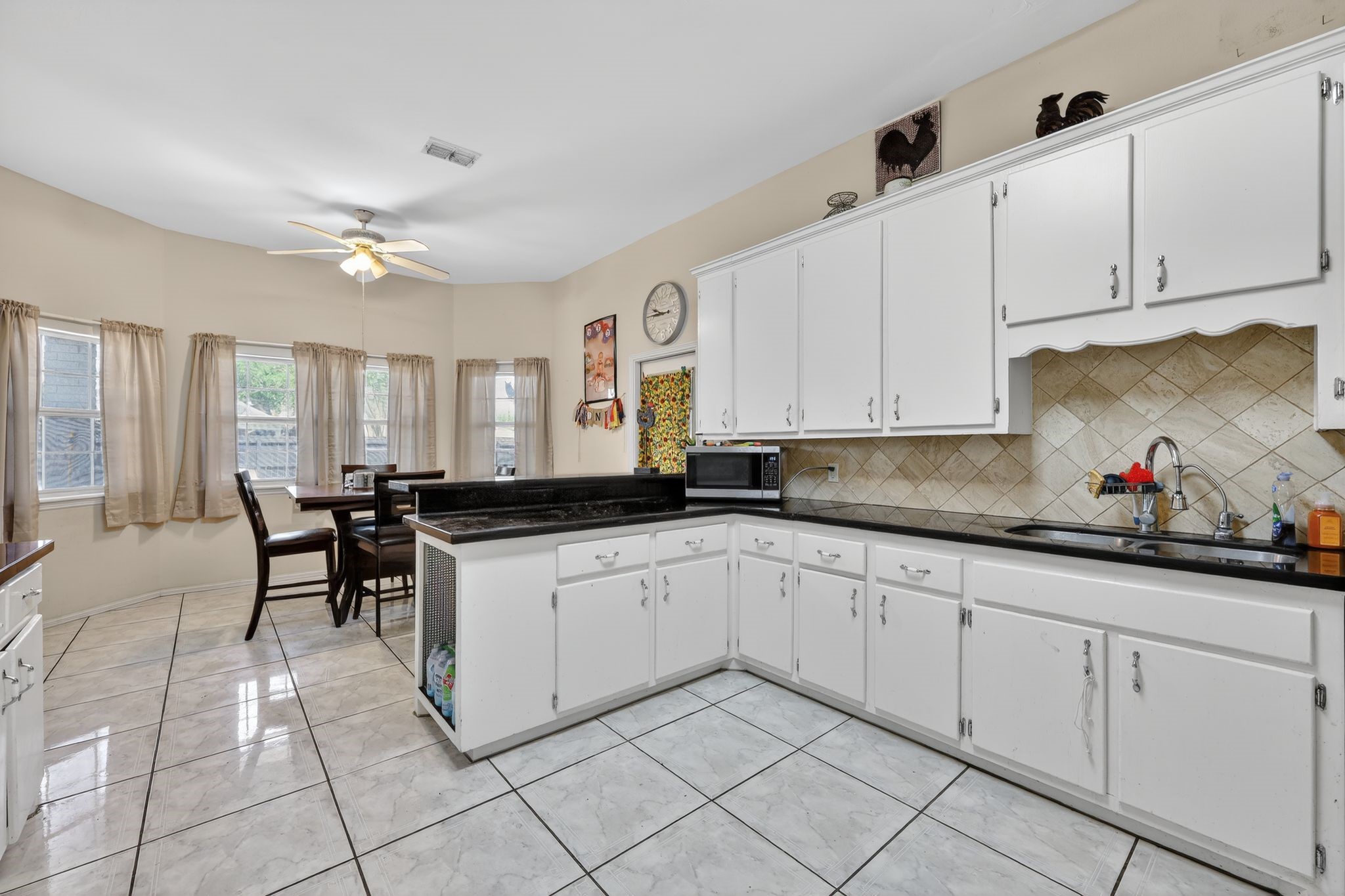 901 Royal Street Edinburg, TX 78539 - Photo 14 of 30 a kitchen with white cabinets and sink