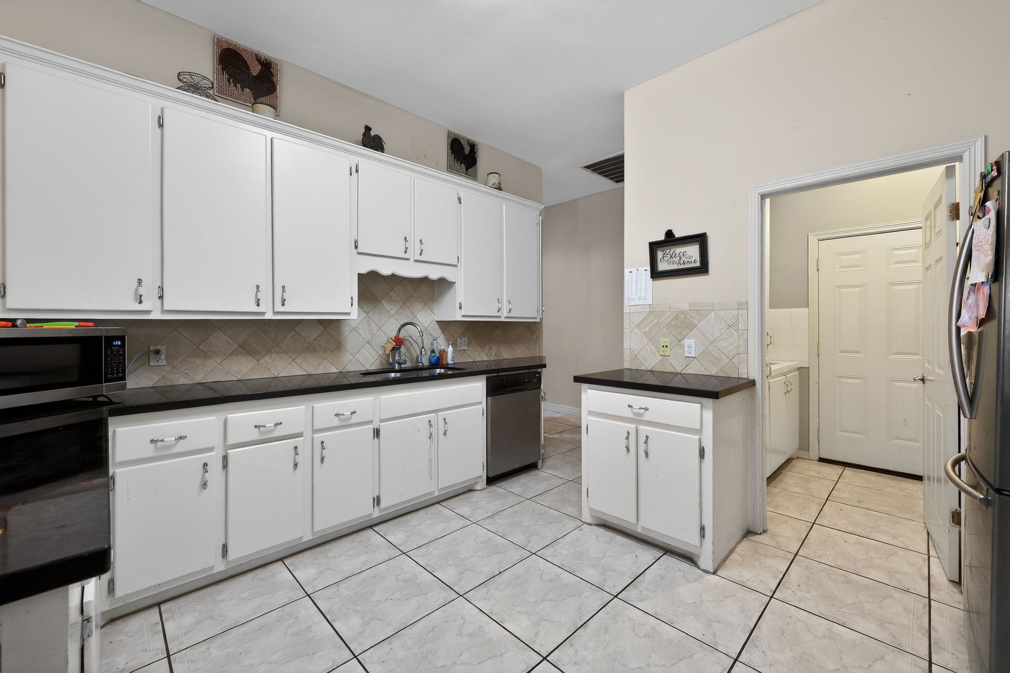 901 Royal Street Edinburg, TX 78539 - Photo 15 of 30 a kitchen with granite countertop white cabinets and white appliances