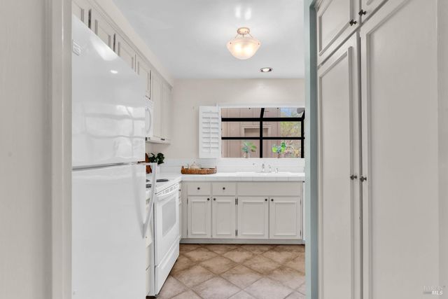 a kitchen with appliances cabinets and a sink