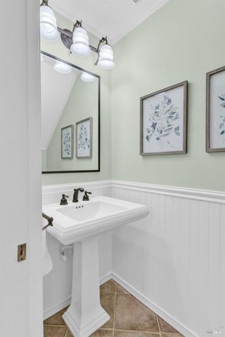 a view of a bedroom with wooden floor and a window