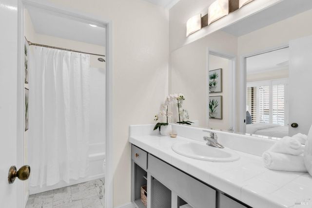 a living room with a bed furniture and a large window