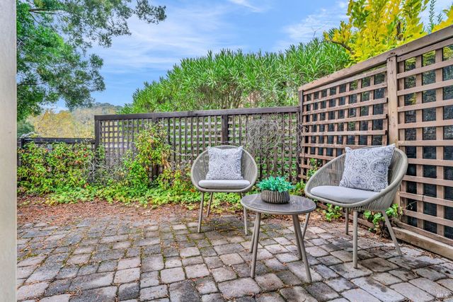 a view of a chairs and table in a back yard of the house