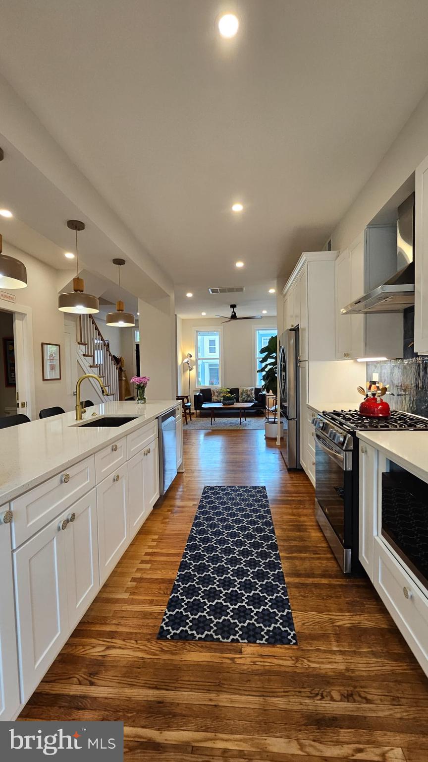 3206 Warder Street Northwest Washington, DC 20010 - Photo 13 of 30 a kitchen with stainless steel appliances granite countertop a stove top oven and cabinets
