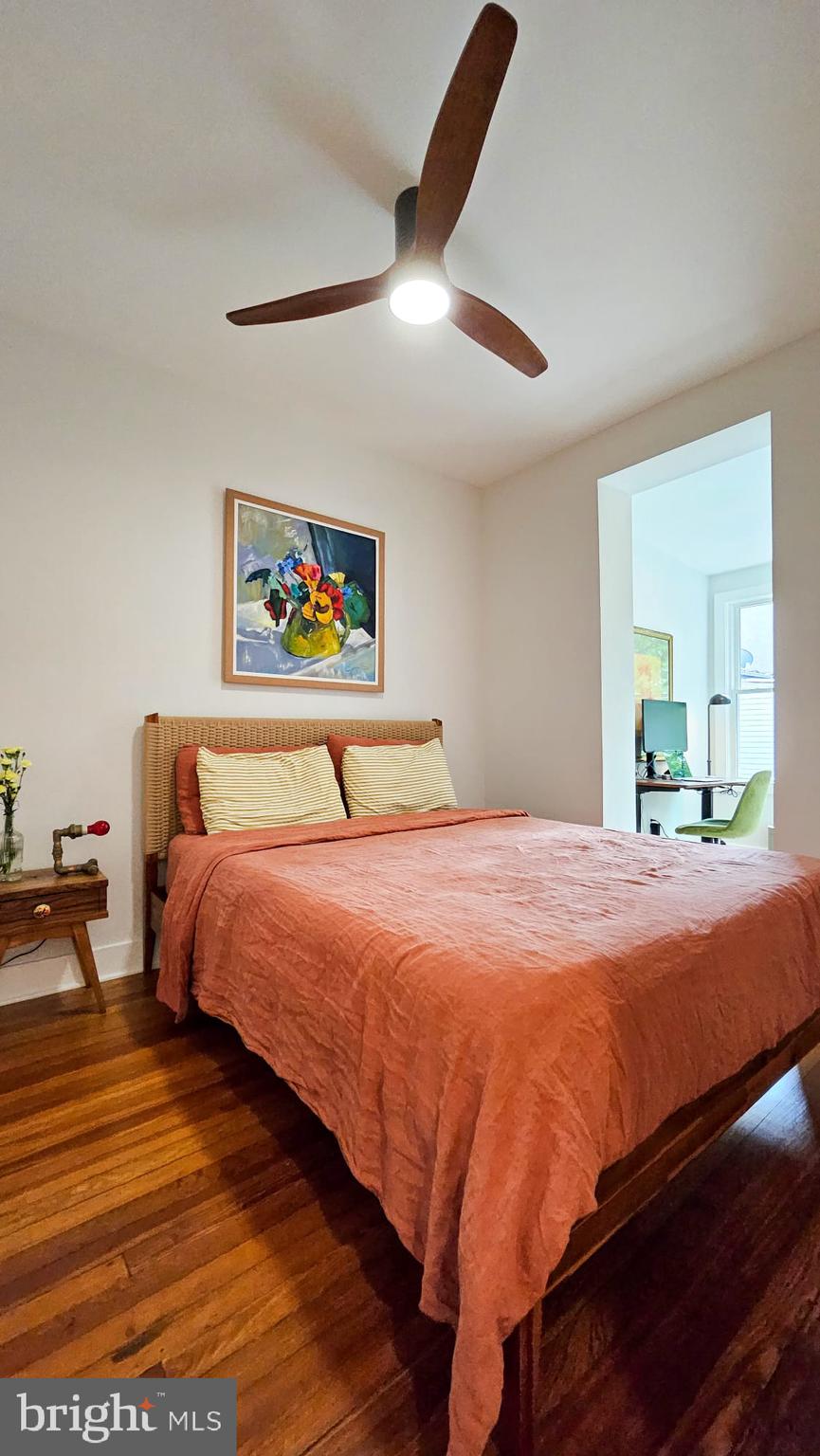 3206 Warder Street Northwest Washington, DC 20010 - Photo 24 of 30 a bedroom with bed and a chandelier
