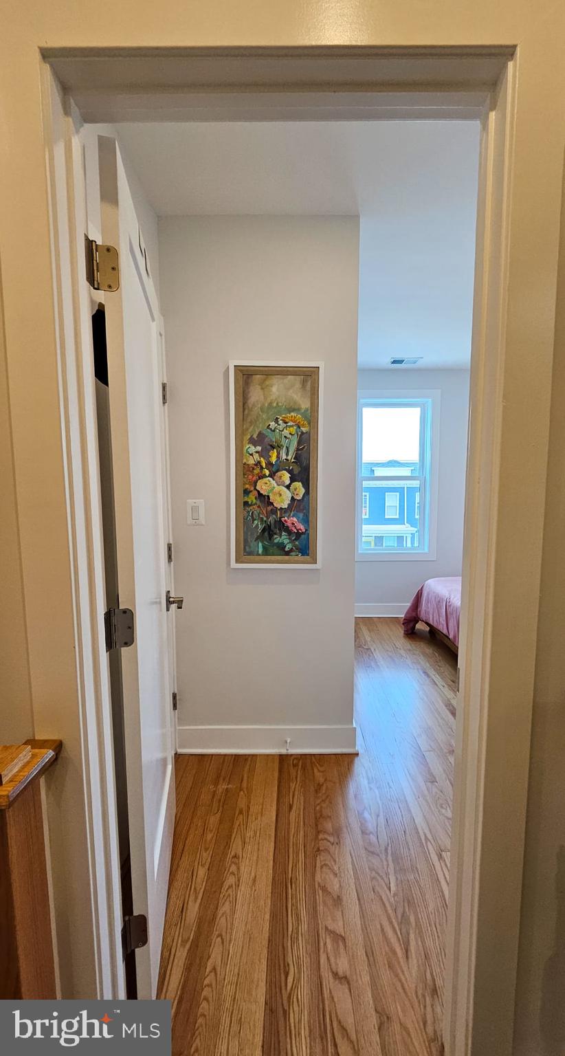 3206 Warder Street Northwest Washington, DC 20010 - Photo 26 of 30 a view of a hallway with wooden floor and stairs