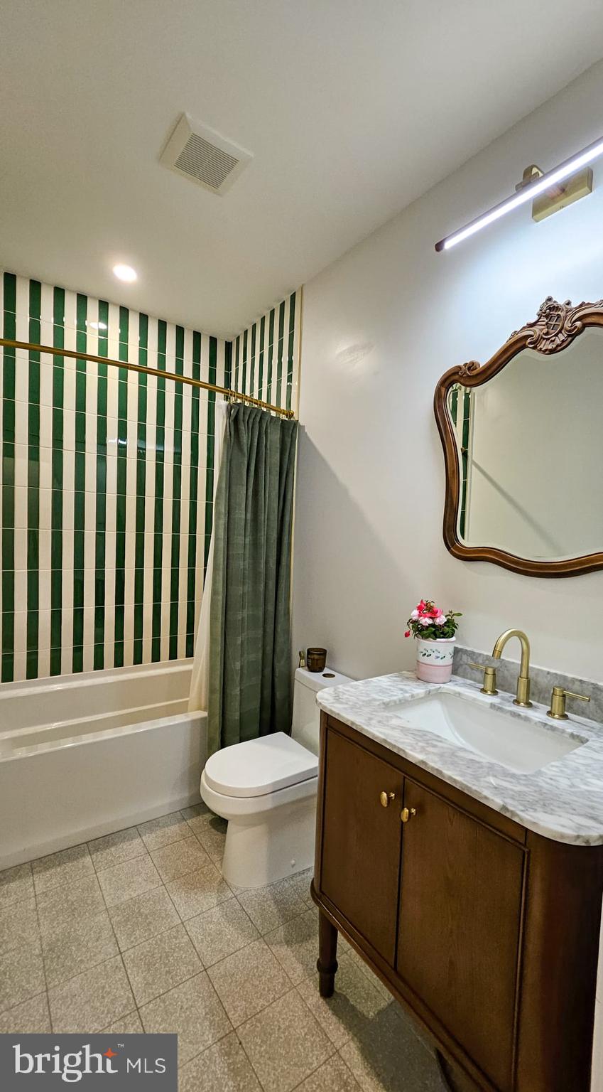 3206 Warder Street Northwest Washington, DC 20010 - Photo 27 of 30 a bathroom with a sink a toilet and mirror