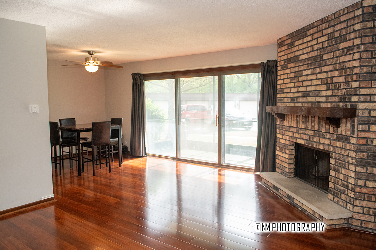 9182 S Road, Unit A Palos Hills, IL 60465 - Photo 3 of 16 a view of a livingroom with furniture fireplace and wooden floor