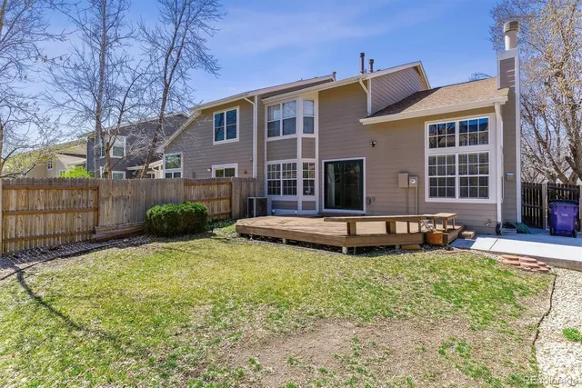 a view of a house with a yard and sitting area