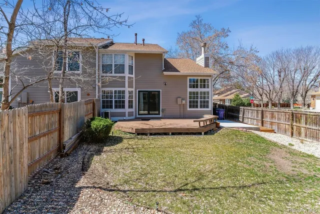 a view of a house with backyard and sitting area