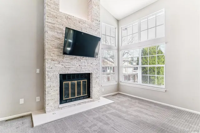 a living room with a fireplace and a flat screen tv
