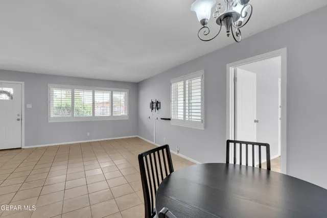 a view of a dining room with furniture and chandelier