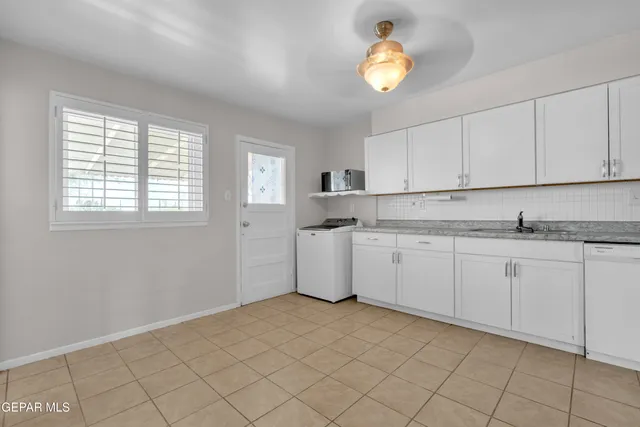 a kitchen with cabinets and a stainless steel appliances