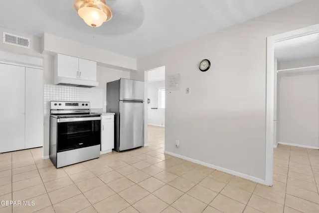 a kitchen with white cabinets