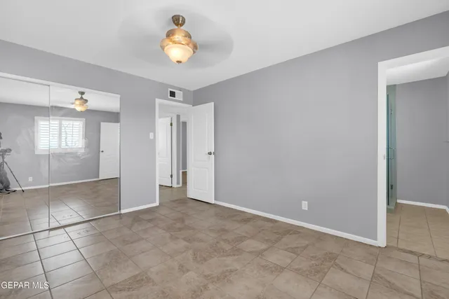 a bathroom with a toilet a sink a mirror a vanity and shower