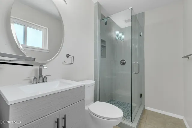 a front view of a house with a yard and potted plants