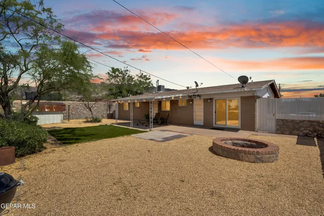a swimming pool with outdoor seating and yard