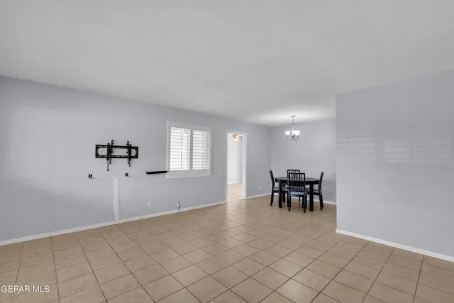 an empty room with furniture and windows