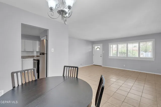 a view of an empty room with wooden floor and windows