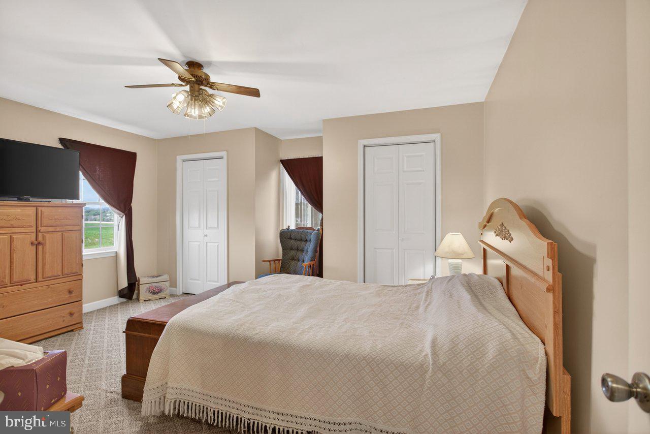 1751 Orchard Road Mount Jackson, VA 22842 - Photo 19 of 30 a bedroom with a bed and a chandelier