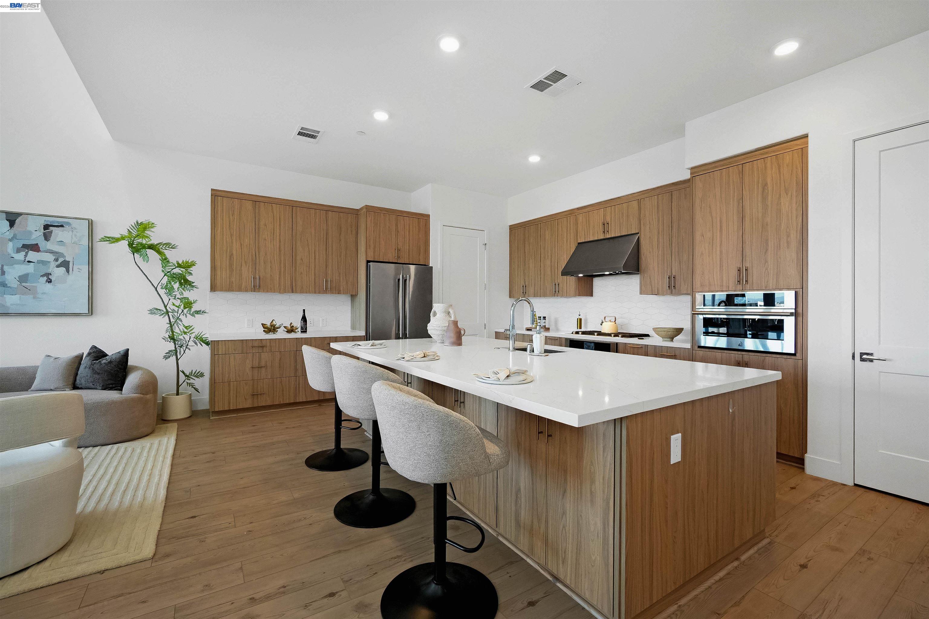 2250 Kilowatt Way, Unit 402 Fremont, CA 94539 - Photo 15 of 51 a kitchen with stainless steel appliances a sink a stove a refrigerator cabinets and chairs