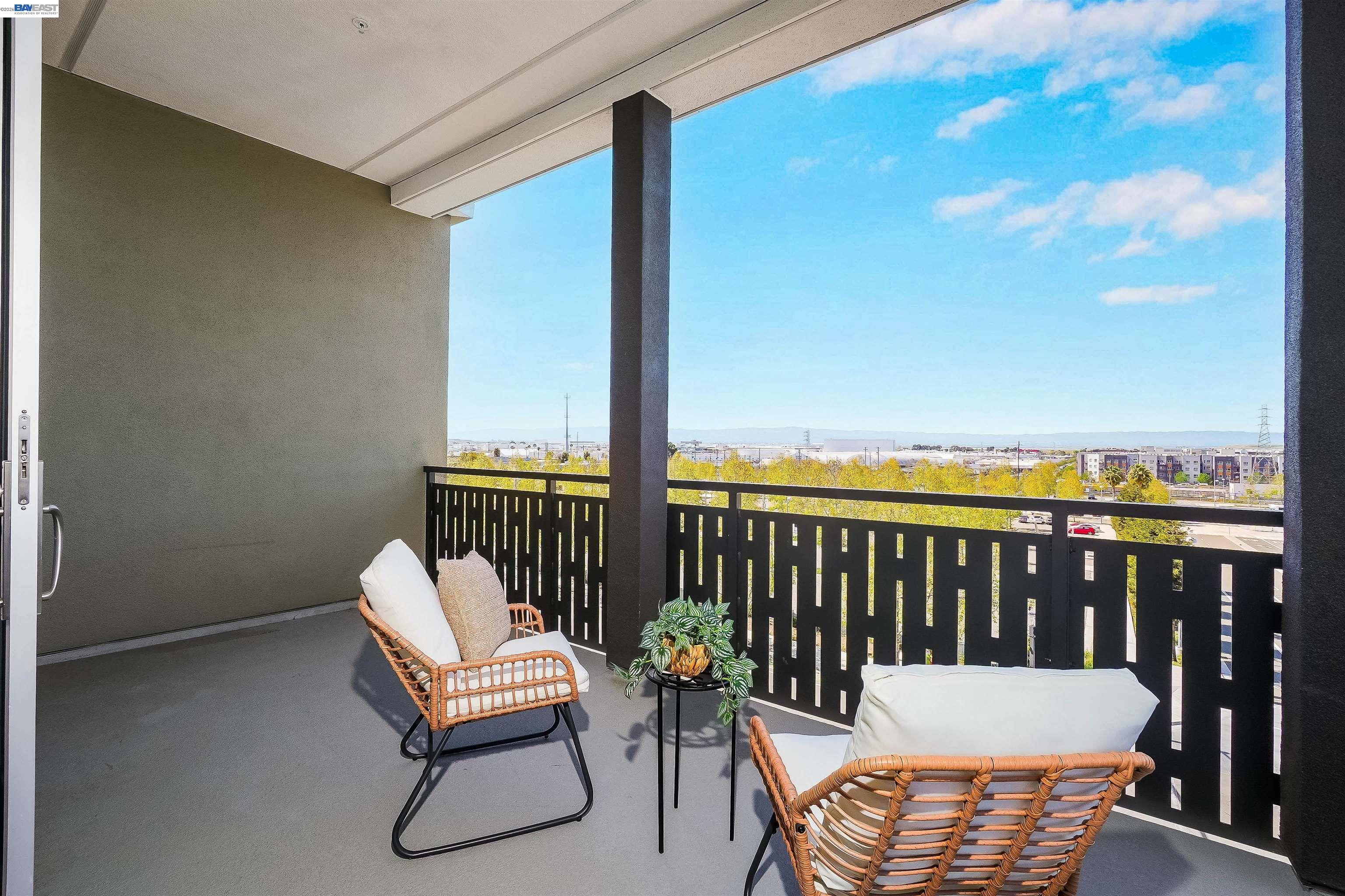 2250 Kilowatt Way, Unit 402 Fremont, CA 94539 - Photo 24 of 51 a balcony with wooden floor outdoor seating and city view