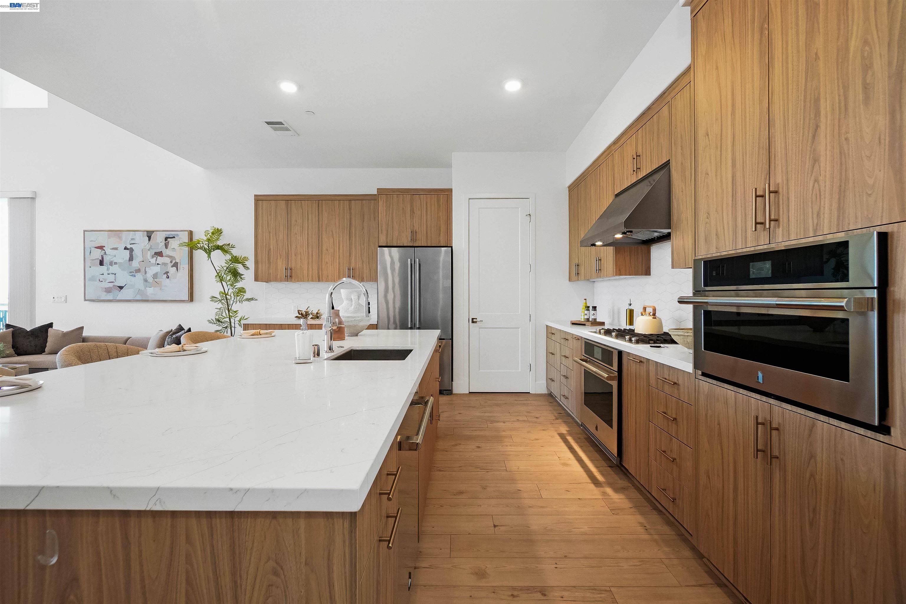 2250 Kilowatt Way, Unit 402 Fremont, CA 94539 - Photo 7 of 51 a large kitchen with kitchen island a stove a sink a refrigerator and cabinets