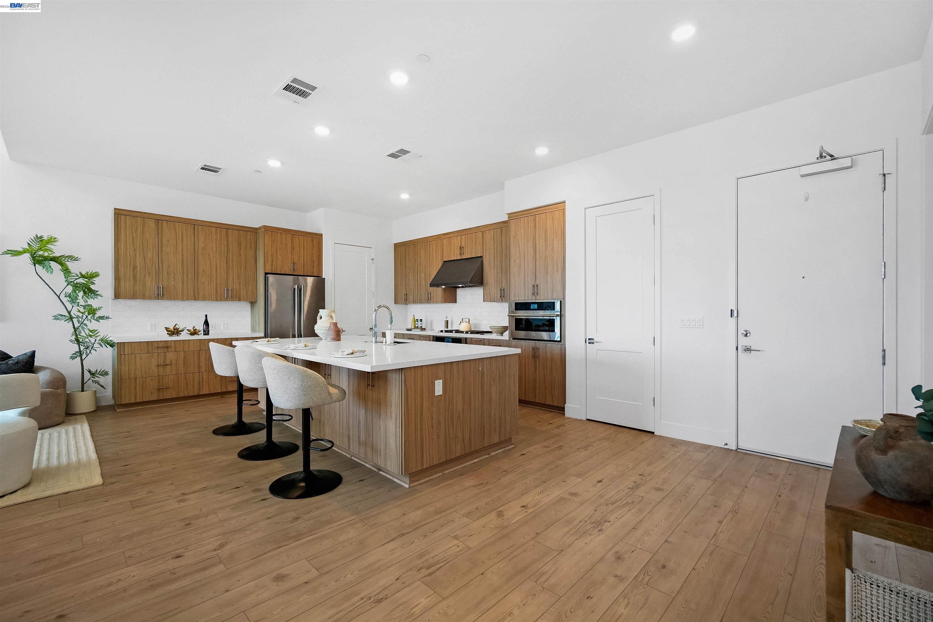 2250 Kilowatt Way, Unit 402 Fremont, CA 94539 - Photo 10 of 51 a kitchen with a sink cabinets and wooden floor