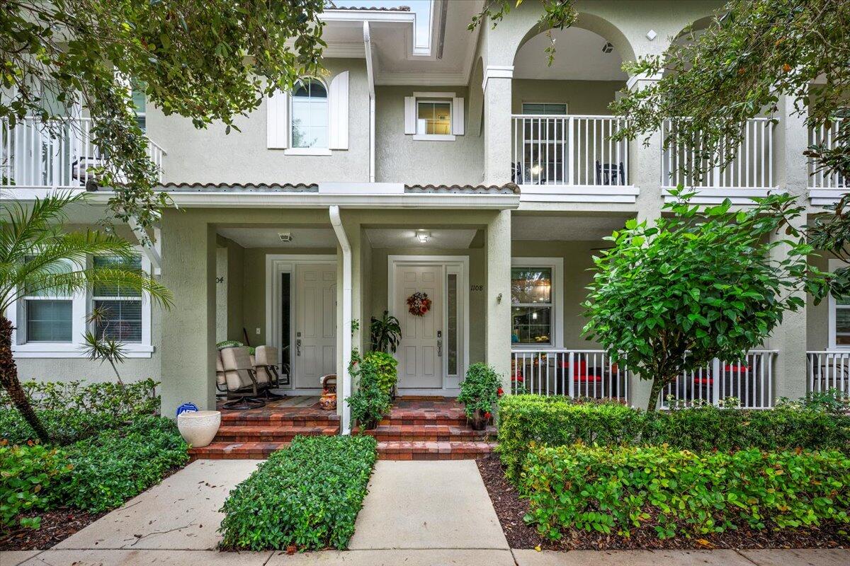 1108 South Community Drive Jupiter, FL 33458 - Photo 14 of 38 a front view of a house with garden