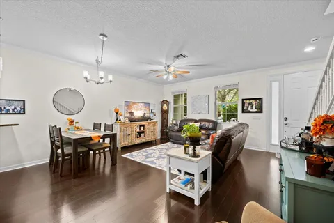 a living room with furniture a ceiling fan and a window