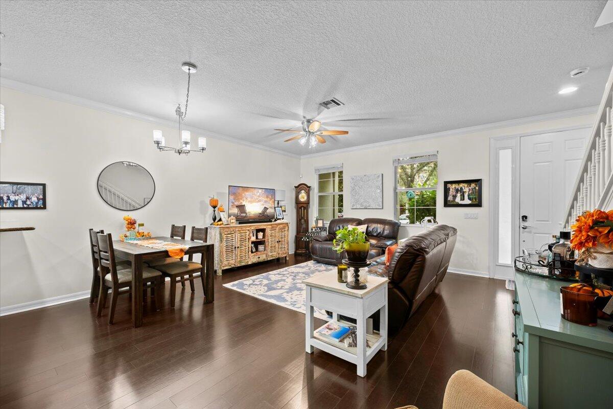 1108 South Community Drive Jupiter, FL 33458 - Photo 15 of 38 a living room with furniture kitchen view and a chandelier