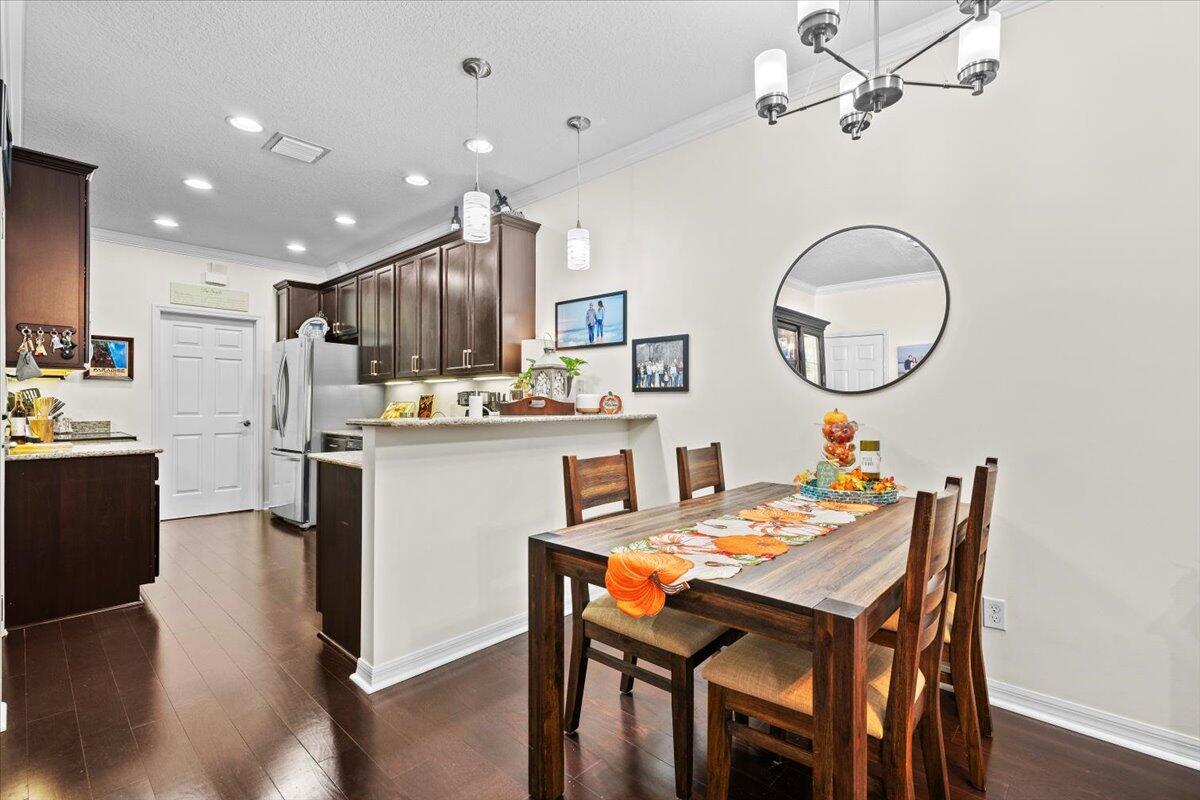 1108 South Community Drive Jupiter, FL 33458 - Photo 16 of 38 a kitchen with a table and chairs in it