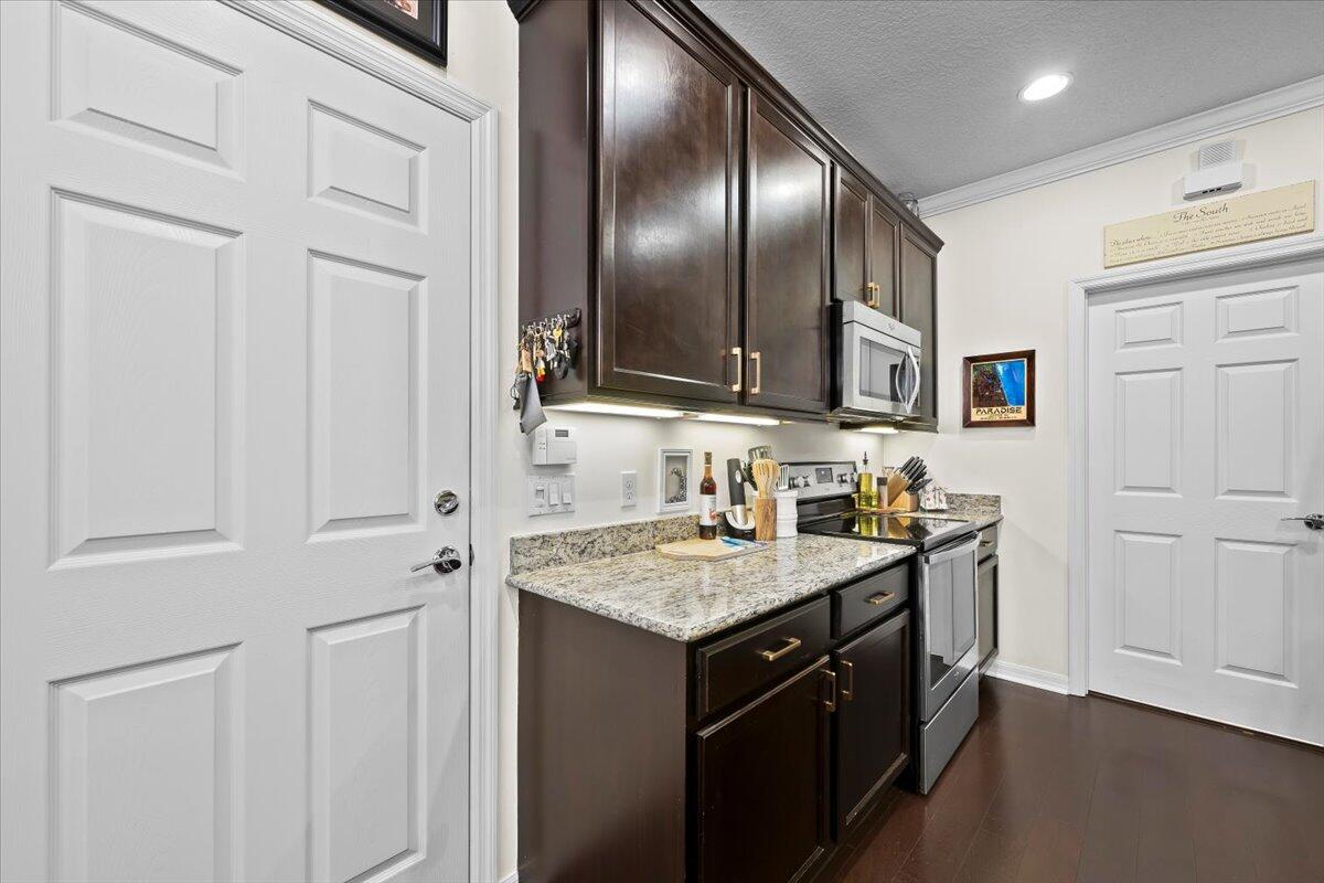 1108 South Community Drive Jupiter, FL 33458 - Photo 19 of 38 a kitchen with stainless steel appliances granite countertop a sink stove and cabinets