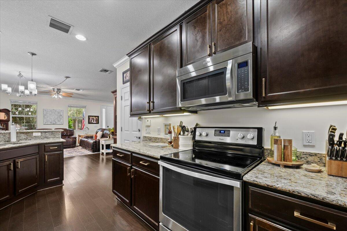 1108 South Community Drive Jupiter, FL 33458 - Photo 20 of 38 a kitchen with stainless steel appliances and sink