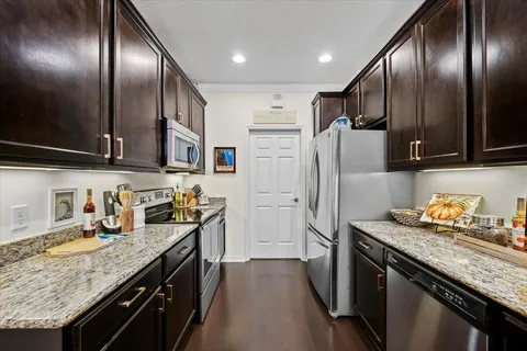 a kitchen with granite countertop stainless steel appliances and wooden cabinets