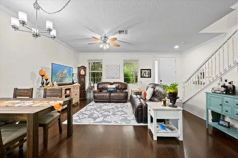 a living room with furniture and a chandelier