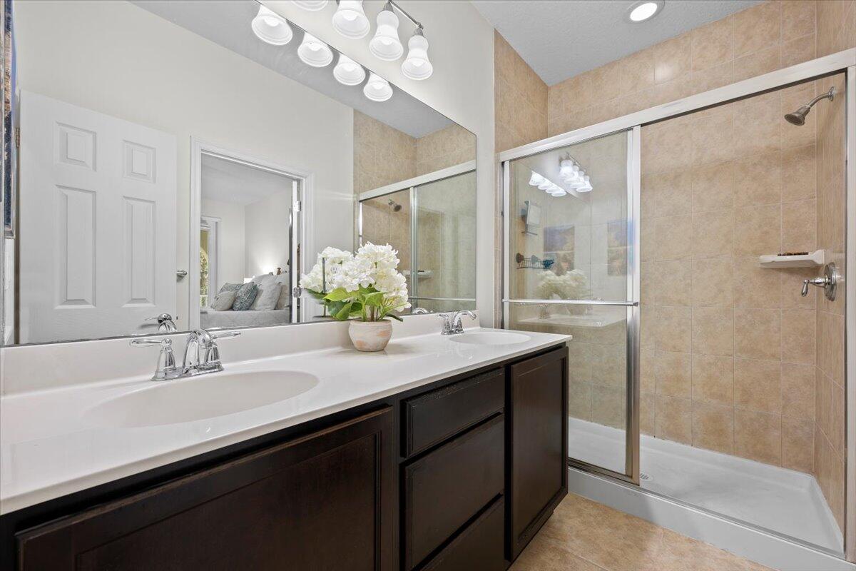 1108 South Community Drive Jupiter, FL 33458 - Photo 6 of 38 a bathroom with a sink double vanity and a mirror