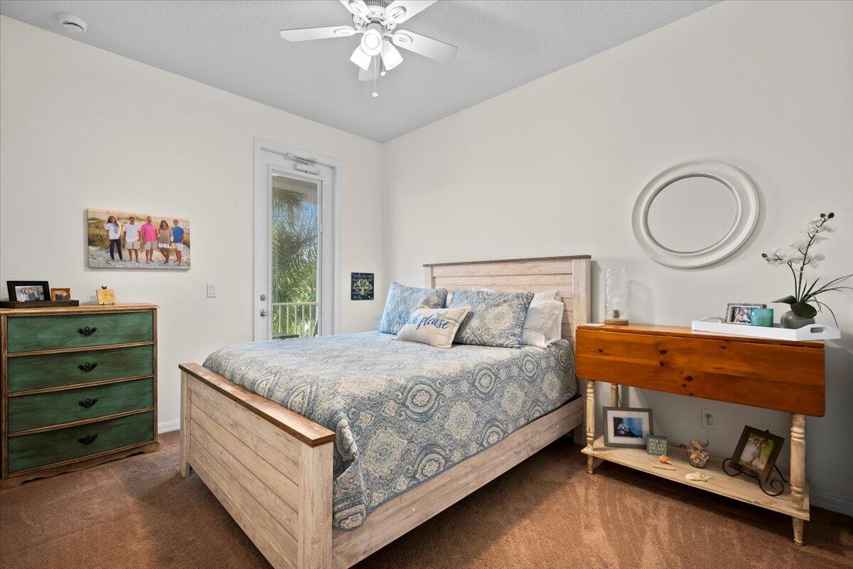 1108 South Community Drive Jupiter, FL 33458 - Photo 8 of 38 a bedroom with a bed and a chandelier