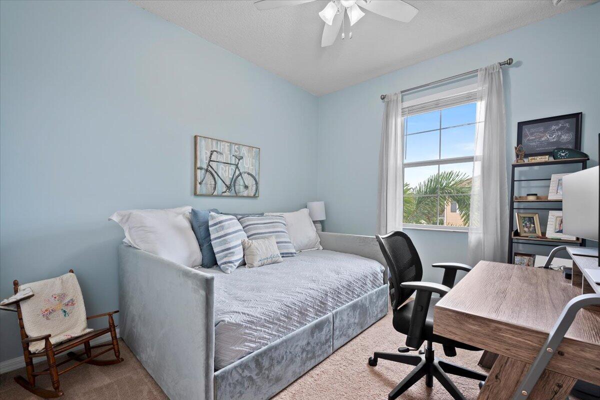 1108 South Community Drive Jupiter, FL 33458 - Photo 9 of 38 a bed room with a bed window and a chair