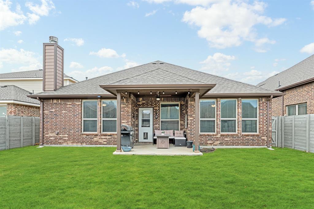 916 Falcon Road Argyle, TX 76226 - Photo 4 of 37 Back of house with a yard and a patio area