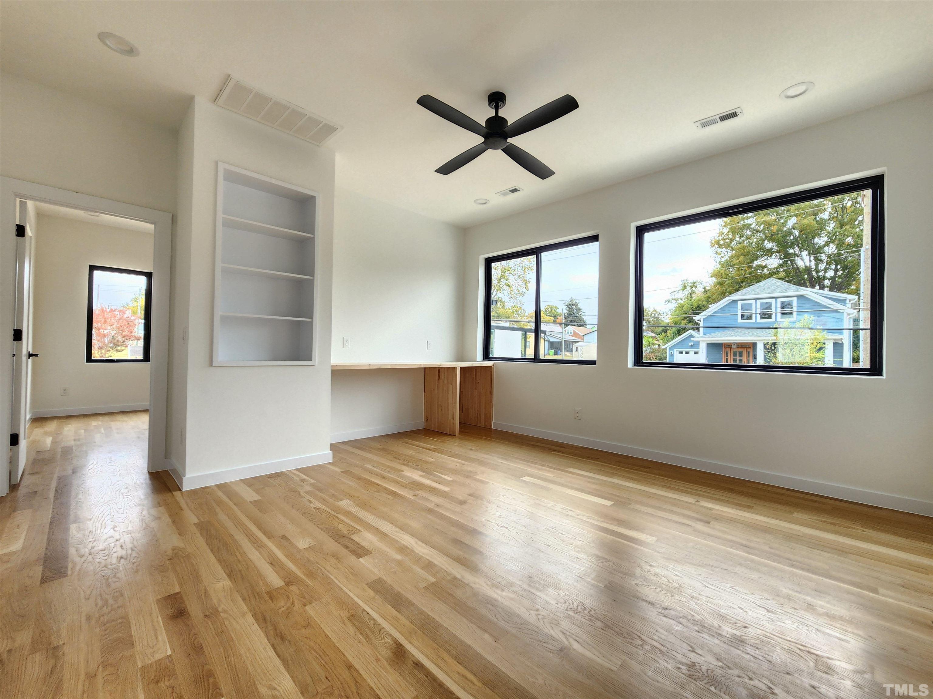 1203 East Lane Street Raleigh, NC 27601 - Photo 11 of 24 a view of empty room with wooden floor and fan