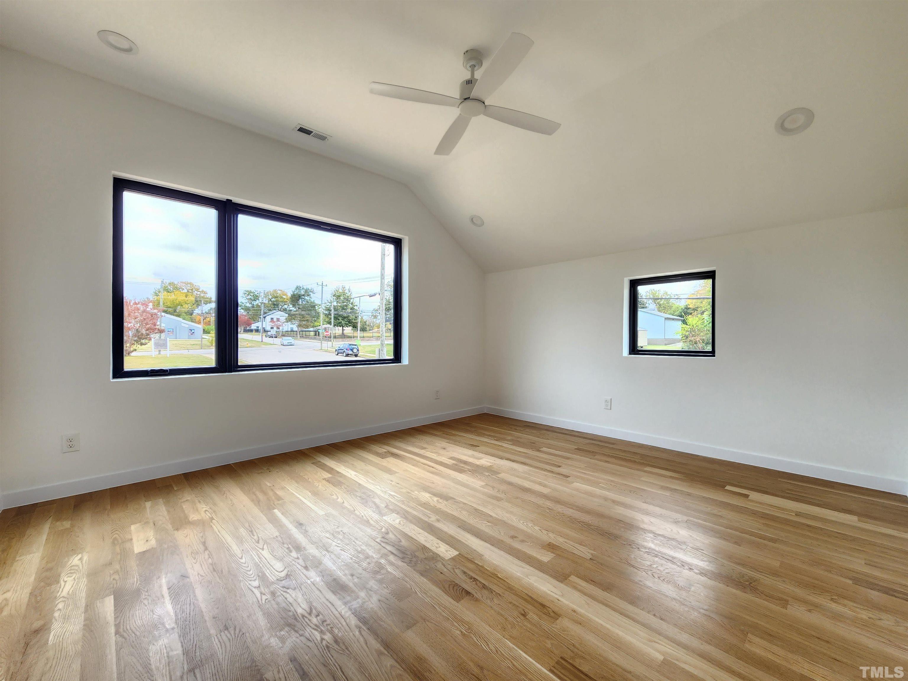 1203 East Lane Street Raleigh, NC 27601 - Photo 12 of 24 a view of an empty room with wooden floor and a window