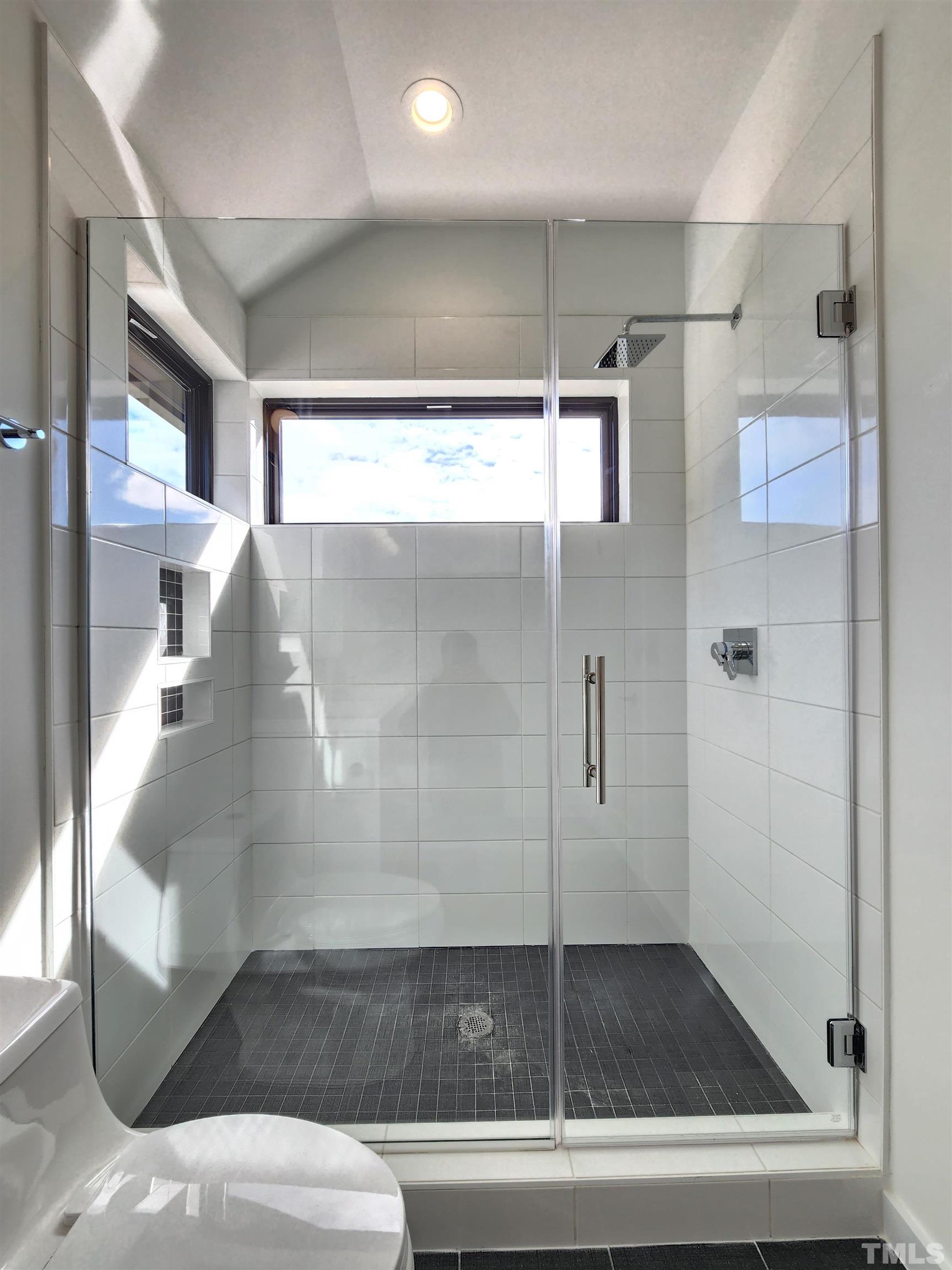 1203 East Lane Street Raleigh, NC 27601 - Photo 14 of 24 a bathroom with a glass shower door