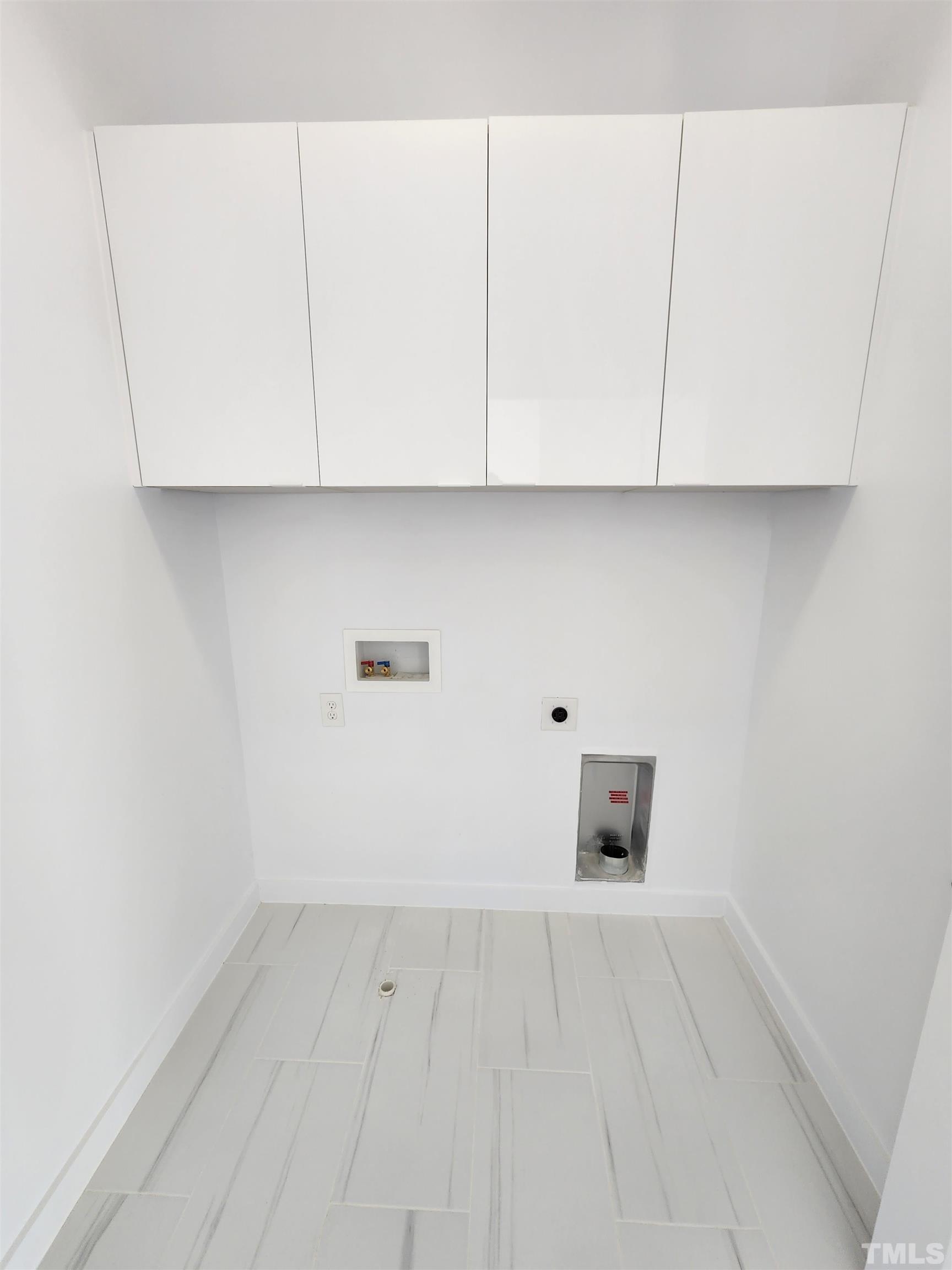 1203 East Lane Street Raleigh, NC 27601 - Photo 17 of 24 an empty room with white cabinets and wooden floor