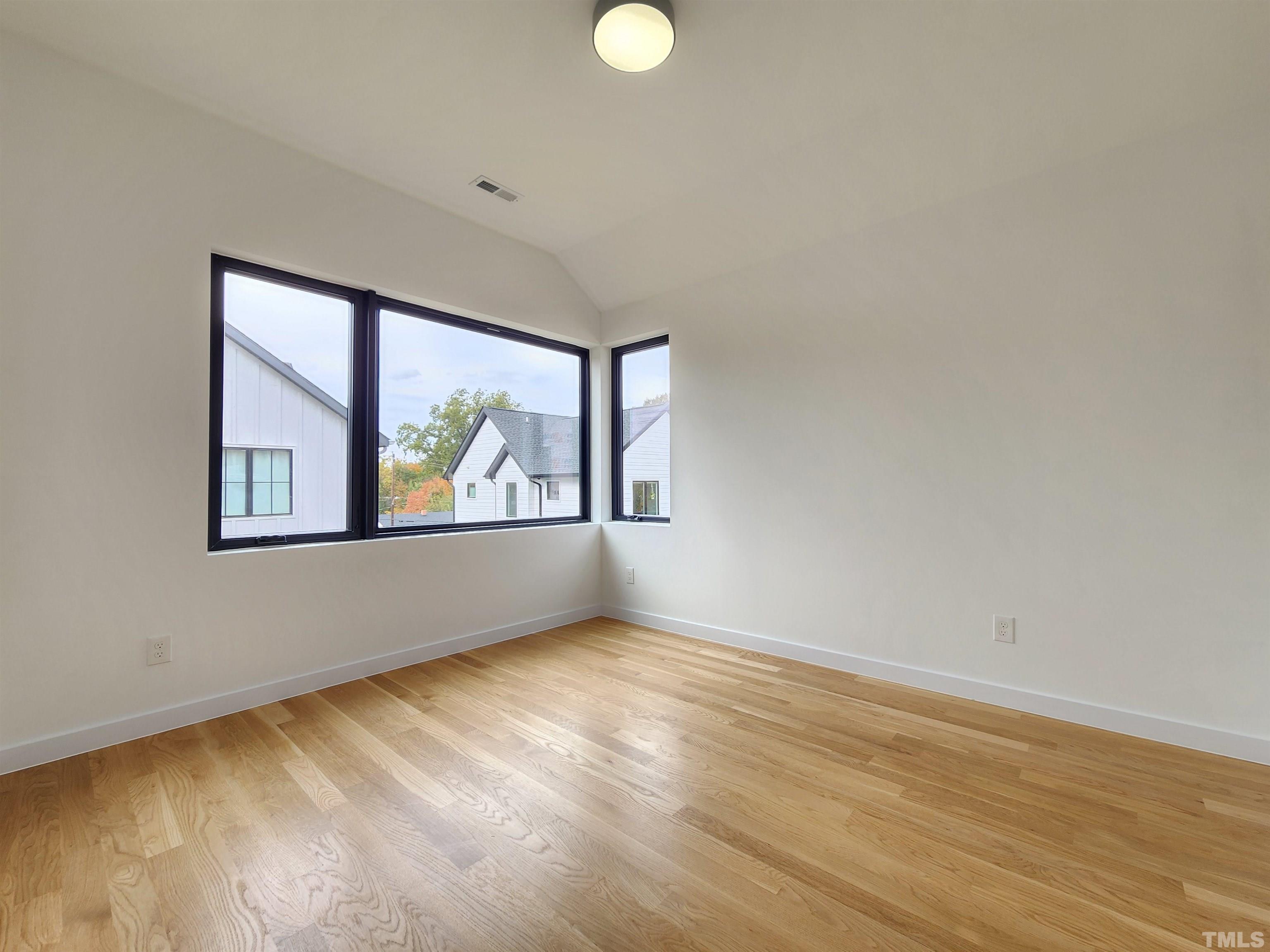 1203 East Lane Street Raleigh, NC 27601 - Photo 18 of 24 a view of an empty room with wooden floor and windows