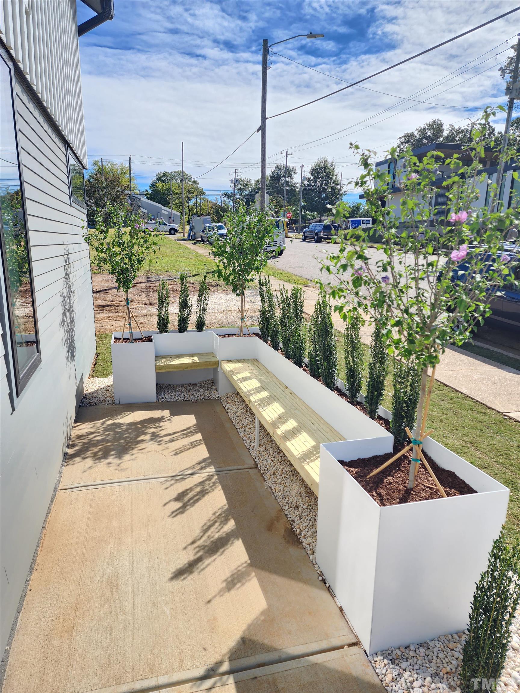 1203 East Lane Street Raleigh, NC 27601 - Photo 3 of 24 a view of a patio with couches table and chairs and potted plants