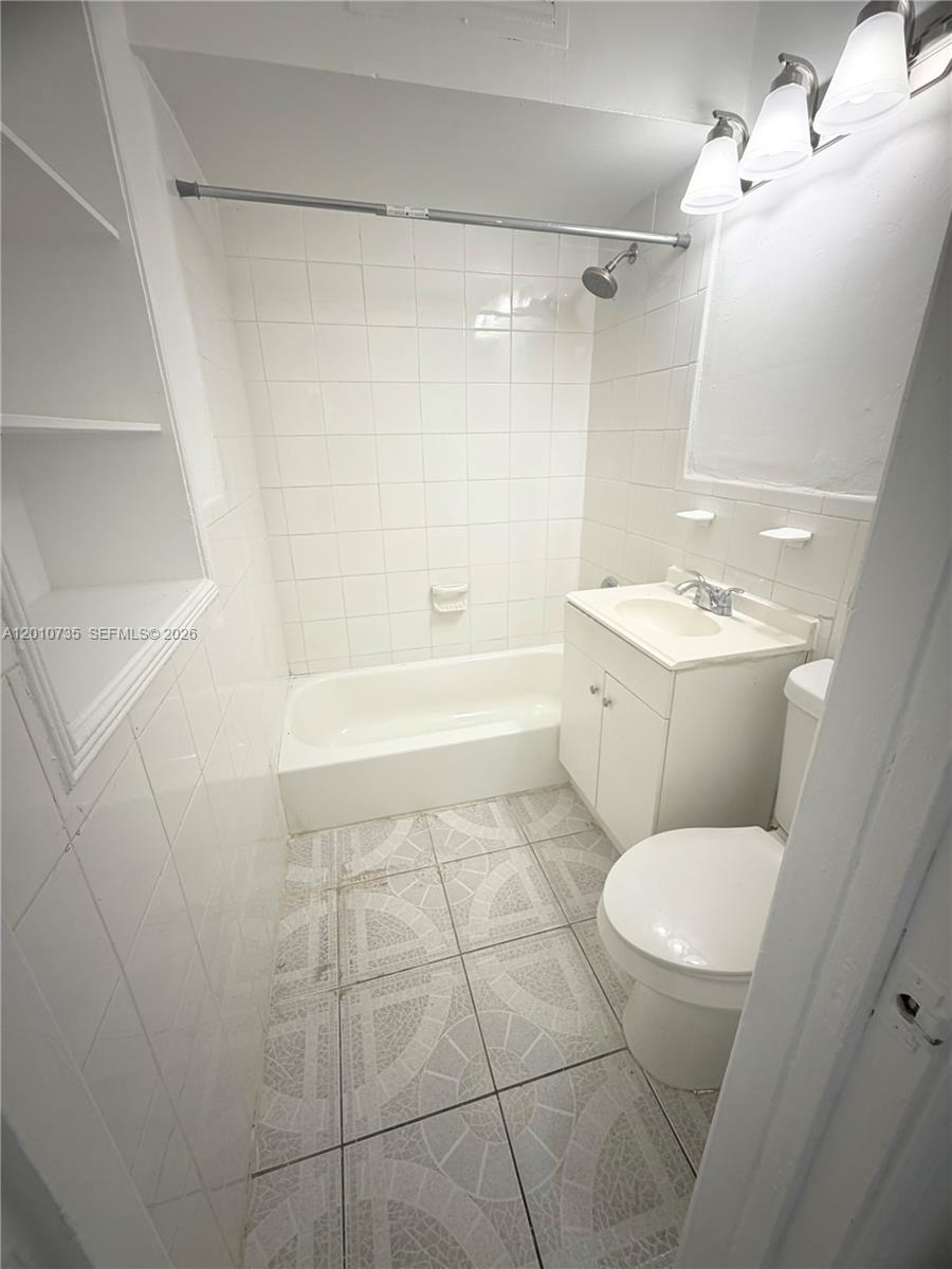 2736 Southwest 22nd Avenue, Unit 2 Miami, FL 33133 - Photo 10 of 12 a bathroom with a toilet a sink and a shower