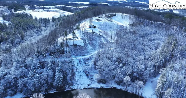 a view of a dry field with trees in the background